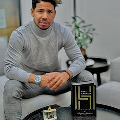 Anderson Ponciano in a gray clothing poses with Morgan Madison HL brand Vol. 2 perfume